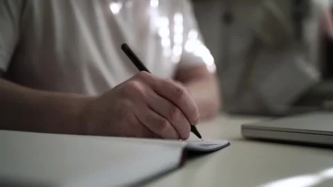 Mans Hand Holding a Pen While Writing on a Notebook. Journaling his thought.. Video stock 306068965