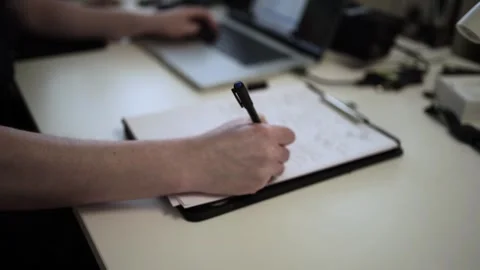 Mans Hand Holding a Pen While Writing on a Notebook. Journaling his thought.. Video stock 306069061