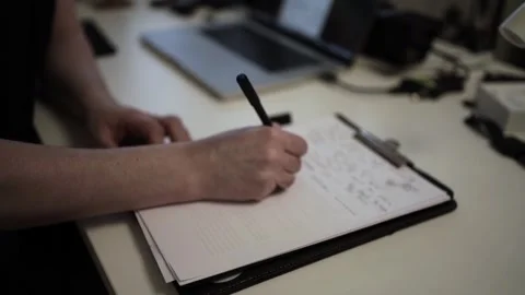 Mans Hand Holding a Pen While Writing on a Notebook. Journaling his thought.. Stock-Footage 306069130