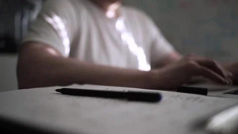 Mans Hand Holding a Pen While Writing on a Notebook. Journaling his thought.. Video stock 306069136