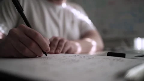Mans Hand Holding a Pen While Writing on a Notebook. Journaling his thought.. Видео 306069144