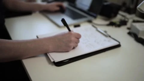 Mans Hand Holding a Pen While Writing on a Notebook. Journaling his thought.. Stock Footage 306069213