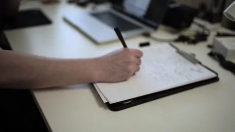 Mans Hand Holding a Pen While Writing on a Notebook. Journaling his thought.. Stock Footage 306069215