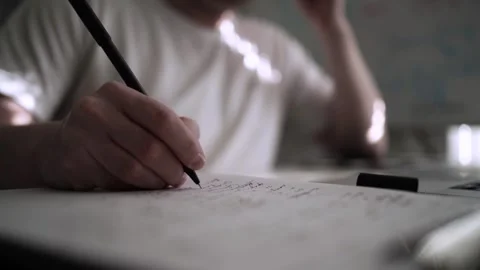 Mans Hand Holding a Pen While Writing on a Notebook. Journaling his thought.. Vídeo Stock 306069274