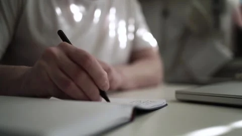 Mans Hand Holding a Pen While Writing on a Notebook. Journaling his thought.. Stock Footage 306069287