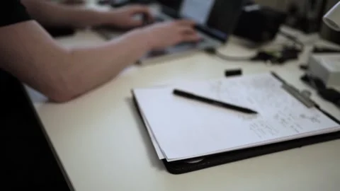 Mans Hand Holding a Pen While Writing on a Notebook. Journaling his thought.. Видео 306069363