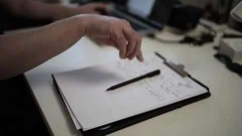 Mans Hand Holding a Pen While Writing on a Notebook. Journaling his thought.. Video stock 306069392