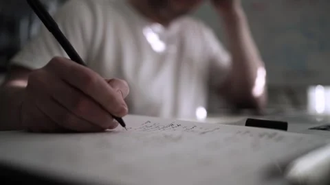 Mans Hand Holding a Pen While Writing on a Notebook. Journaling his thought.. Stock-Footage 306069406