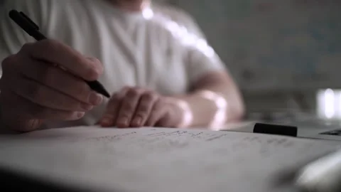 Mans Hand Holding a Pen While Writing on a Notebook. Journaling his thought.. Video stock 306069412