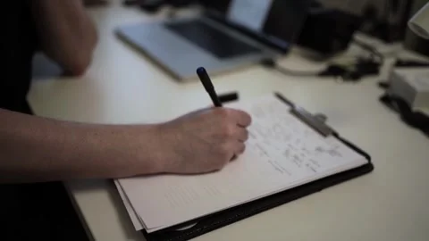 Mans Hand Holding a Pen While Writing on a Notebook. Journaling his thought.. Stock-Footage 306070042