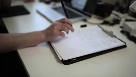 Mans Hand Holding a Pen While Writing on a Notebook. Journaling his thought.. Stock-Footage 306070150