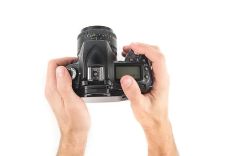 Mans hand holding a professional camera  isolated on a white background. Stock Photos