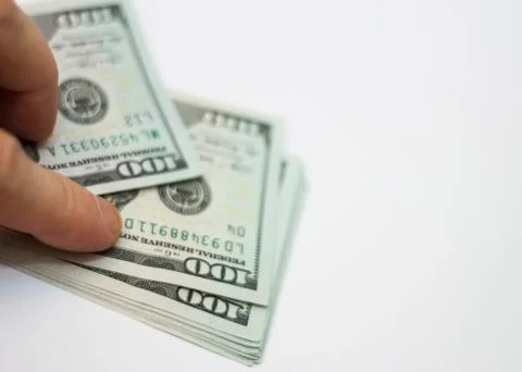 Mans Hand Holding A Stack Of Paper Dollars Usa On The White Background Stock Photos