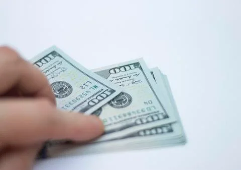 Mans Hand Holding A Stack Of Paper Dollars Usa On The White Background Stock Photos