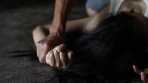 Man's hand holding woman's hand for rape and sexual harassment.A social pro.. Stock Footage 336935716