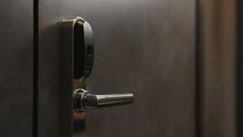 A man's hand holds up an electronic key and opens the closed door. Stock Footage 170646828