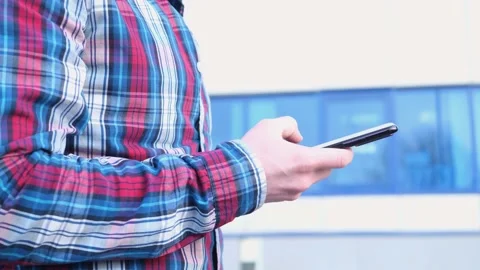 A man's hand holds a smartphone. Stock Footage 152334476