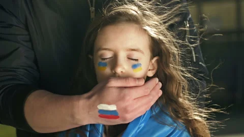 Man's hand with the image of the Russian flag roughly closes the mouth of a Stock Footage 172393820
