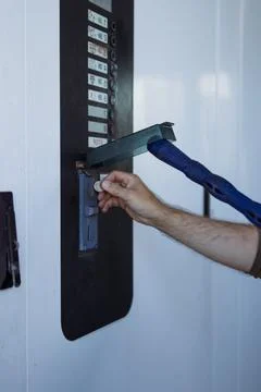 Man's hand inserting coin into self-service car wash machine, paying for wa.. Stock Photos