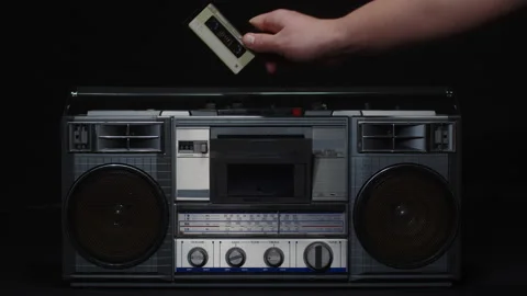 A man's hand inserts a cassette into a tape recorder and presses the play button Stock Footage 170717489
