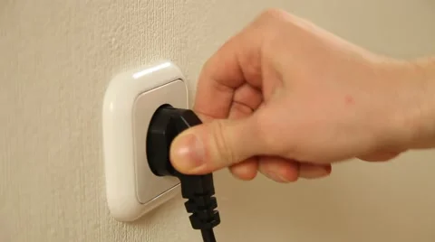 Man's hand inserts a plug into a socket Stock Footage 61268879