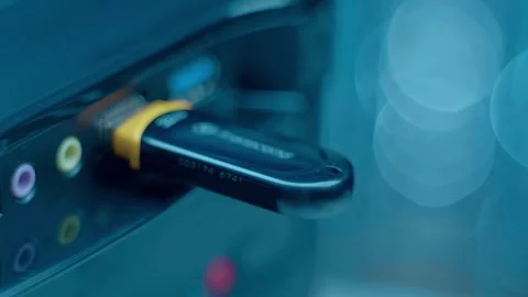 A man’s hand inserts (remove) a black, shiny flash drive into the USB port  Stock Footage 259689016