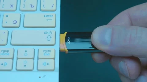 A man’s hand inserts (remove) a black, shiny flash drive into the USB port  Stock Footage 259693667