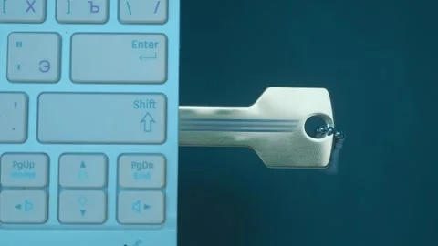 A man’s hand inserts (remove) a computer flash drive in the form of a golden key Stock Footage 259689039