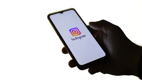Man's hand with instagram icon logo on the phone. instagram social app Stock Footage 196277298