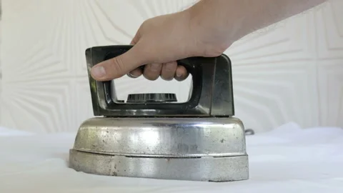 A Man's hand Ironing Clothes. Close-Up. Stock Footage 104298650
