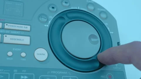 A man's hand on Jog Shuttle video editing console, collects a clip and push mark Stock Footage 259725067