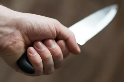 Man's hand with a kitchen knife Stock Photos