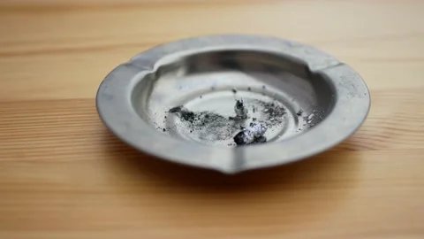 Man's hand that knocks the ashes from a burning cigarette into an ashtray Stock Footage 137133773
