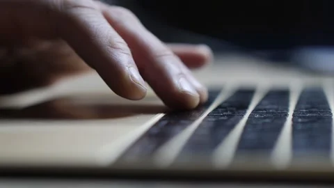 A man's hand on a laptop keyboard. man typing on keyboard Stock Footage 154253313