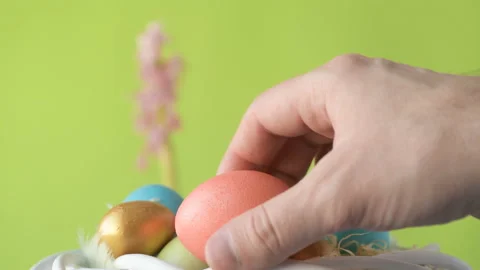 Man's hand lays down colourful Easter eggs Stock Footage 148290279