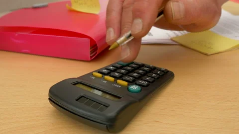 Man's hand with a letter, then using a calculator and writing figures. Video stock 196075201