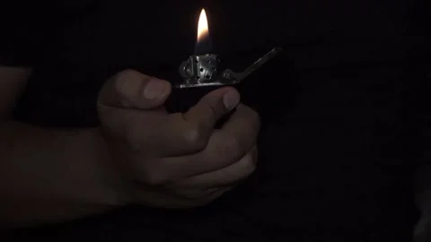 Man's hand lighting gas lighter, close-up view Stock Footage