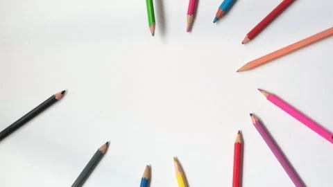 Man's Hand lLaying Out Colored Pencils On White Background Stock Footage 340548925