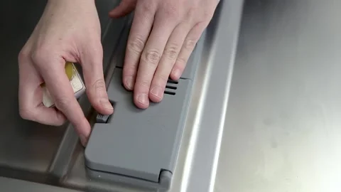 The man's hand loads detergent "all in one" in the dishwasher Stock Footage 167797244