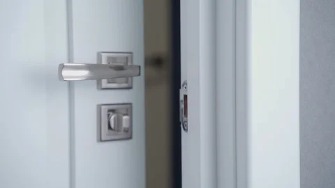 A man's hand locking the door Stockbeeldmateriaal 125187879