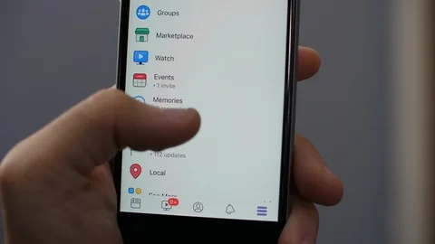 Man's hand logging out of Facebook App account on iPhone. Stock Footage 96272694