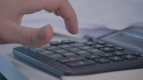 A man's hand makes calculations on a calculator close plan Video stock 164673181