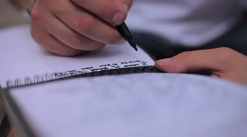 Man's Hand With Marker Writes Text in Notepad Stock Footage 66550660
