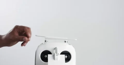 Man's hand mount a remout controller's antenns Stock Footage 76995557