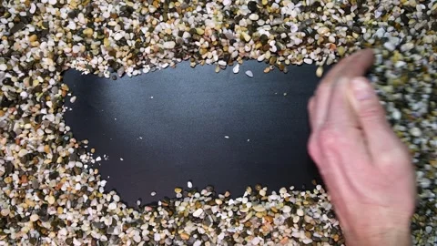 Man's hand moves aside small natural aquarium stones Stock Footage 334615904