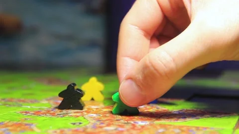 Man's hand moves the chips in the board game carcassonne Stock Footage 222637681
