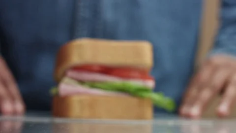Man's hand moving the sandwich to focus zone to camera Stock Footage 84596225