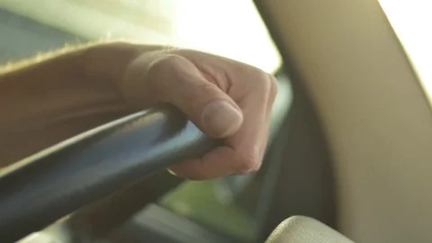 Man's hand moving the steering wheel while driving the car Stock Footage 73690377