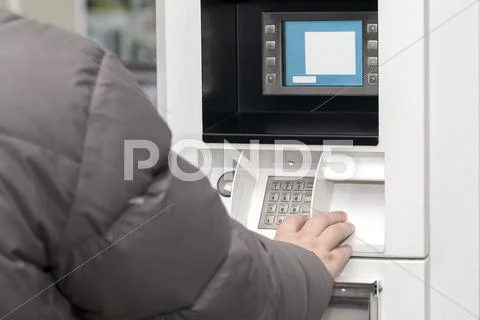 Man's hand near the cash machine in Gas Station Stock Photos