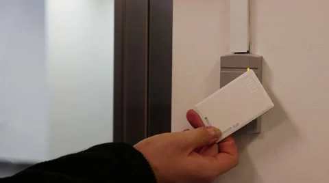 Mans hand open secure door with key card Stockbeeldmateriaal 59008504